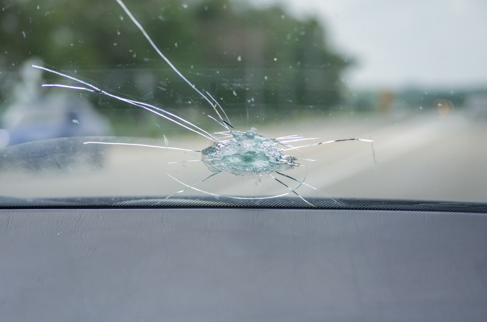 Chipped windshield from a rock as the car is driving down the highway